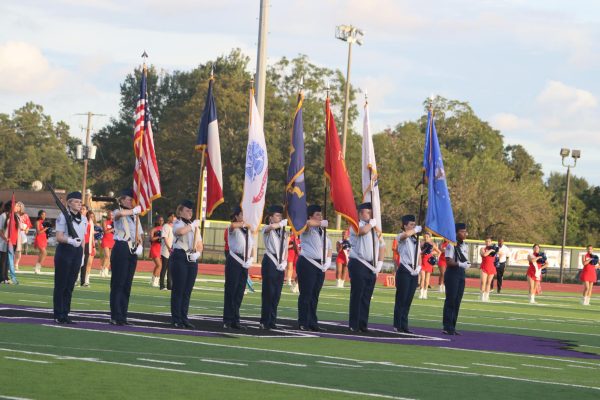 LAND OF THE FREE. Members of the AFJROTC color guard presents the flags at the first home game of the season. 