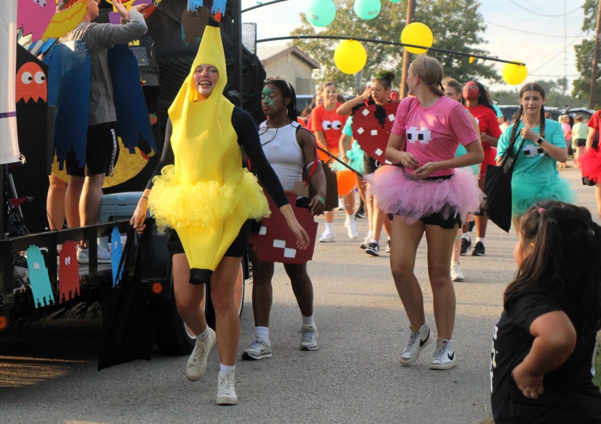 BANANAS ABOUT THE KATS. With her teammates from the basketball team, senior Abi Mize dresses as a character to Ms. PacMan. 