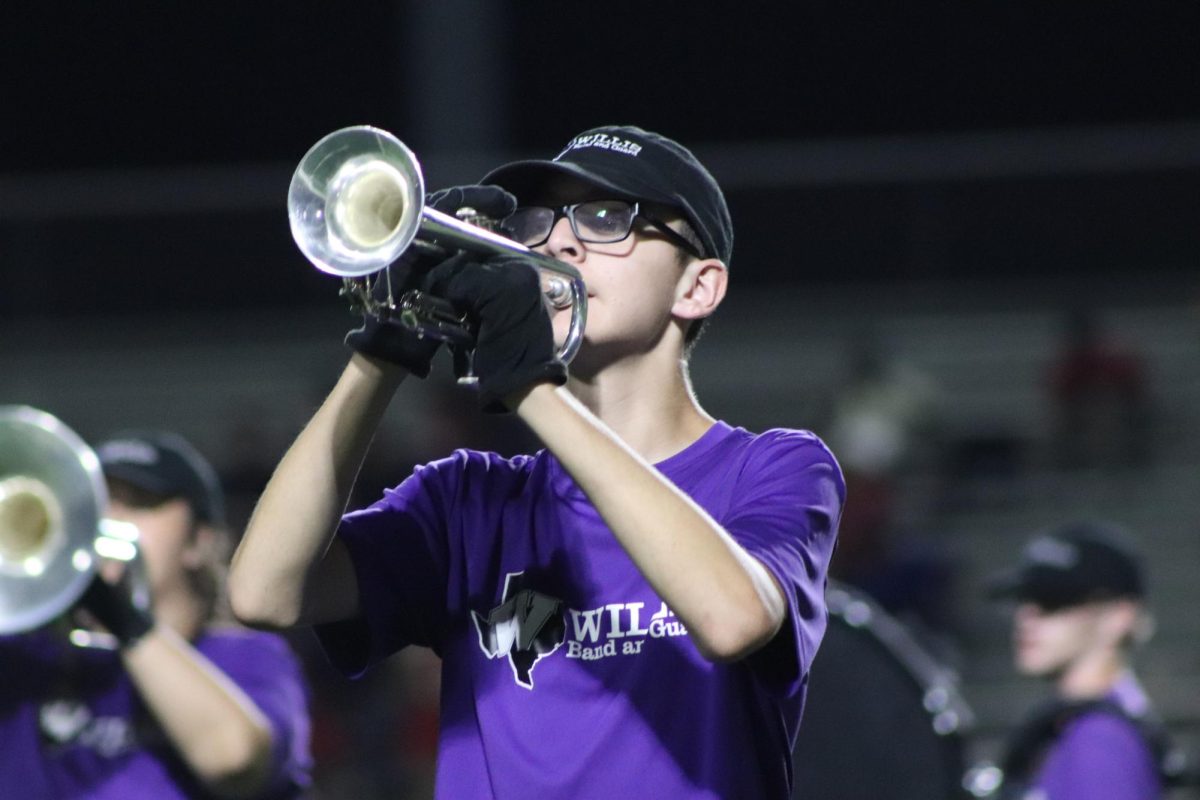 FIRST PERFORMANCE. During the halftime show at the first home game, junior Robbie King plays with the Wildkat Band. This was the debut of the halftime show that will be the band's contest show, Dimensions and Destiny.