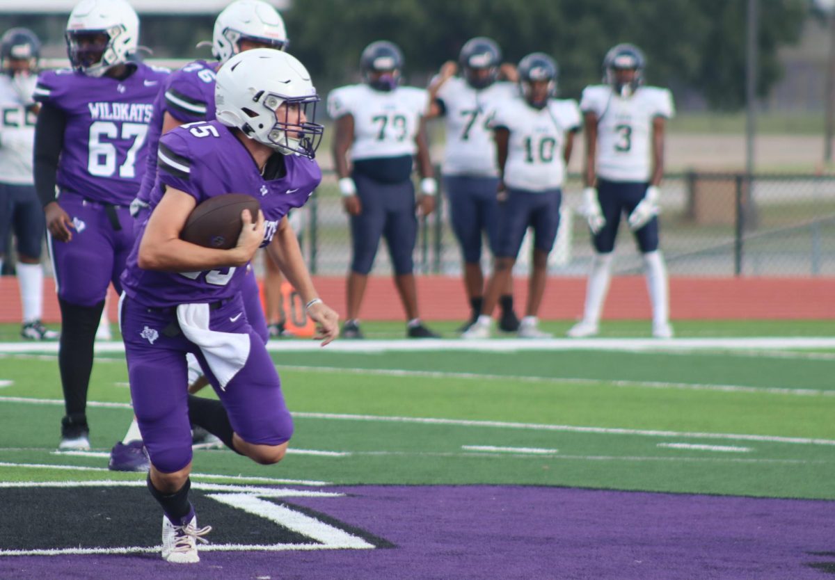 LEADING THE WAY. In the Wednesday night game against Klein Collins, sophomore quarterback Kash Abke runs, looking for a first down for the Kats.  Because of a Thursday night game for varsity, JV and freshmen teams played their games on Wednesday. 