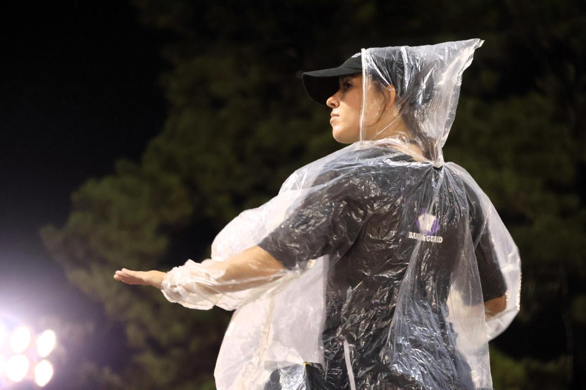 LEADER OF THE BAND. Not letting a little rain stop the fun, senior Faith Nichols leads the band during the game against Klein Collins game Thursday night. 