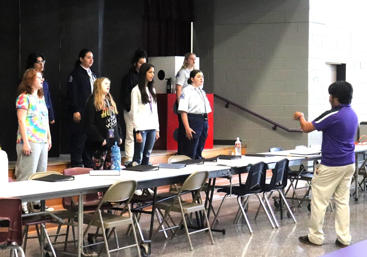 CLASS TIME PRACTICE. Getting used to the cafeteria acoustics, assistant choir director Brandon Ramos practices with his second period class on Wednesday. 