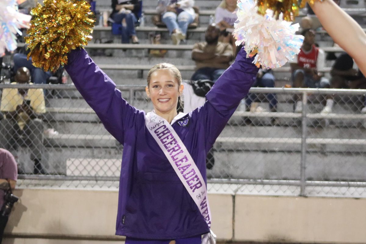 CHEERS IN THE RAIN. Cheerleader of the week Kyndall Schniffer cheers on the sidelines of the Klein Collins game.  The Kats won the game 40-7.