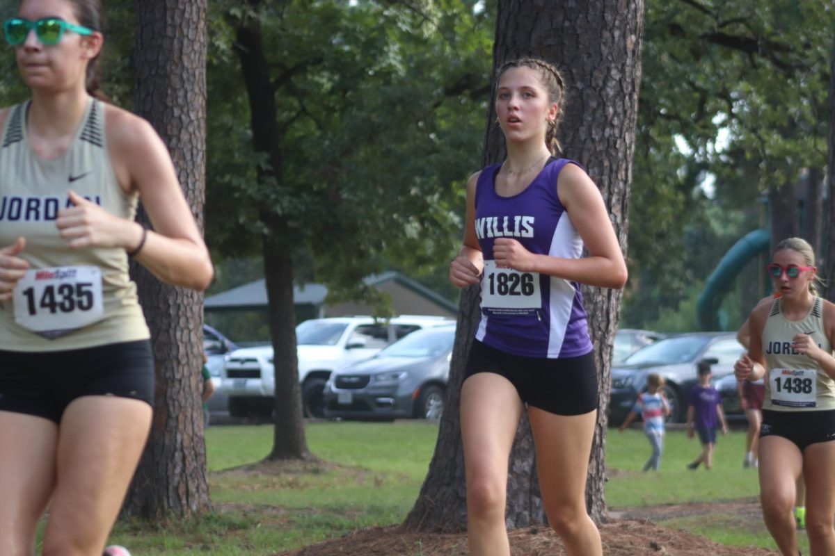 NEW RUNNING KAT. Running at the CyFair meet, junior Lucia Yvanez paces herself for a strong finish. As a exchange student, this is Yvanez's first year on the cross country team. 