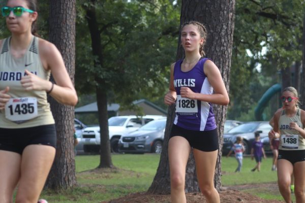 NEW RUNNING KAT. Running at the CyFair meet, junior Lucia Yvanez paces herself for a strong finish. As a exchange student, this is Yvanez's first year on the cross country team. 