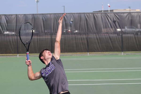 SERIES SWEEP. Playing boys doubles against Cleveland, junior Bryce Bickley serves against his opponent. The Wildkats played Cleveland as part of the district team competition. 
