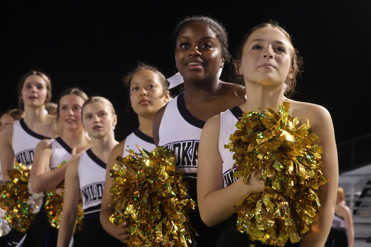 NAIL BITER. The last seconds of the game were high stakes. On the sidelines, cheerleaders watch in anticipation as senior kicker Justin Willis makes the winning field goal. 