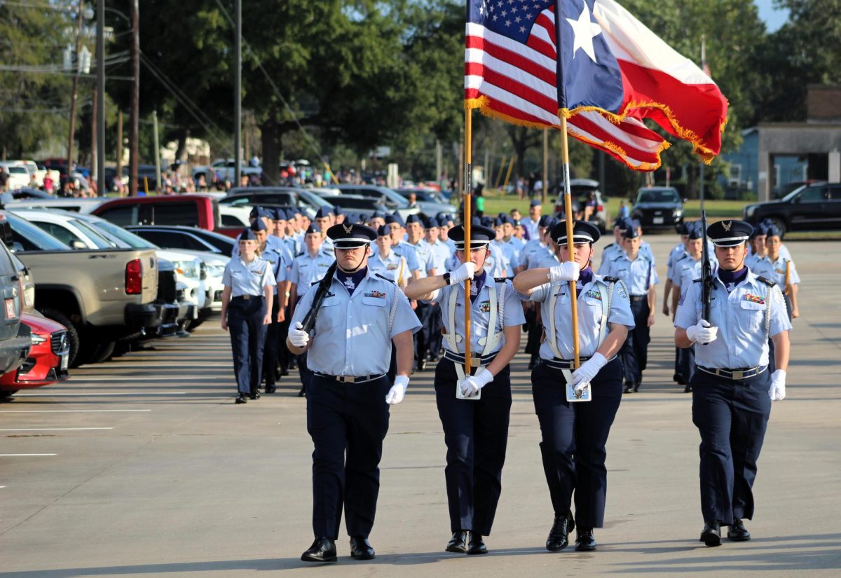 LAND OF THE FREE. Starting the parade off with the stars and stripes, members of the AFJROTC color guard carry the American and Texan flag at the beginning on the homecoming parade on Wednesday. The rest of the corp marched behind them led by senior Christopher Aleman.  photo by Heavin Bell