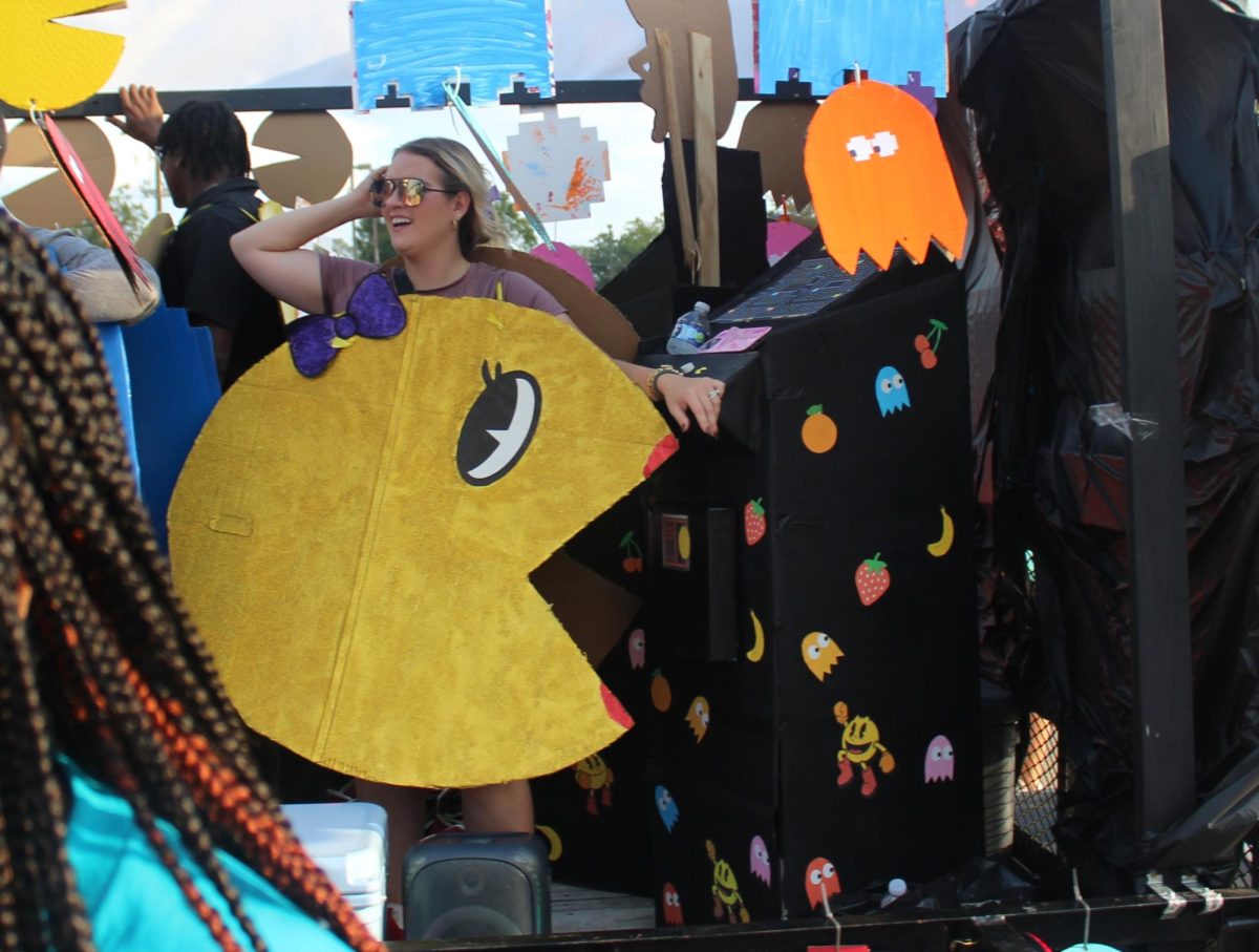 PAC-MAN FEVER.  Flashing back to the 80s as Ms. pacman, coach Kaley Evans rides the basketball float. The Ms. Pac-Man theme tied for first with the Jumanji-themed volleyball float. 