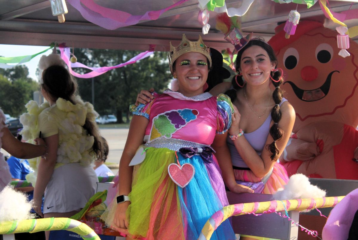 SWEET SENIORS. On the cosmo float themed after the Candyland theme, seniors Mallori Mitchell and Laurel Hall ride during the parade.