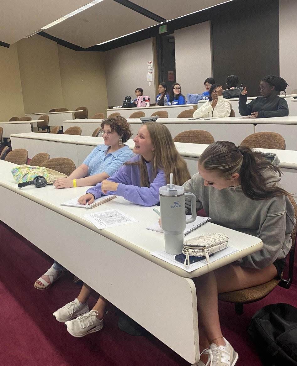 STUDIOUS SMILES. Senior Kaitlin Burns and sophomores Addison Arnaud and Ashtyn King hang around laughing before a lecture about journalism. The Lone Star campus invited many schools to go and learn about vital points on how to do well in UIL events.