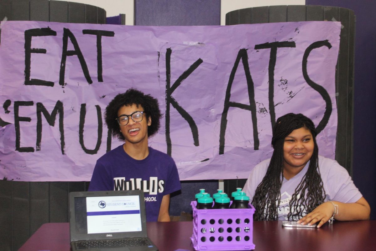 LEADERS. Recruiting prospective members during the 8th grade visits, juniors Isiah Higgins and Mia McGowen represent student council.