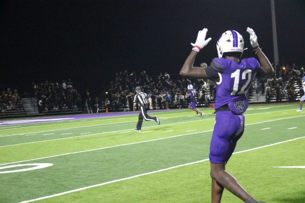 TOUCHDOWN. As his teammate senior Jalen Mickens heads to the endzone, senior Romel Stevens signals the imminent touchdown against Oak Ridge. Mickens accumulated 114 receiving yards in the game with six receptions.