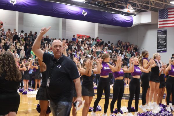 WILKDAT PRIDE. At the first pep rally of the year, principal Eric King sings the school song. 