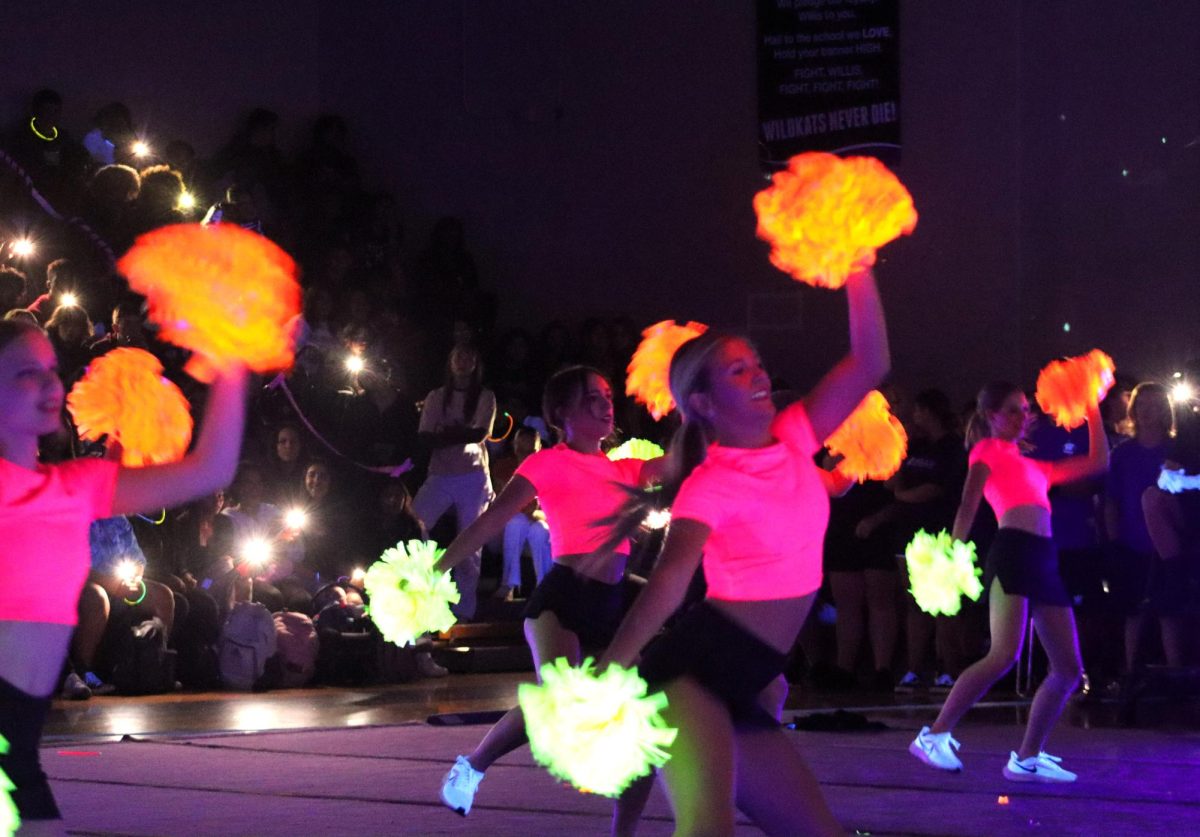 LET'S GET GLOWING. At the 2023 black out pep rally junior Josie Oatman dances and glows  