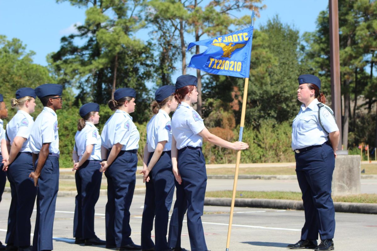 AT EASE. During the Oak Ridge Iron Eagle competition, junior Phoenix Rushing sets the cadets at ease during the unarmed drill. The team won second overall and brought home eight trophies after the competition. 