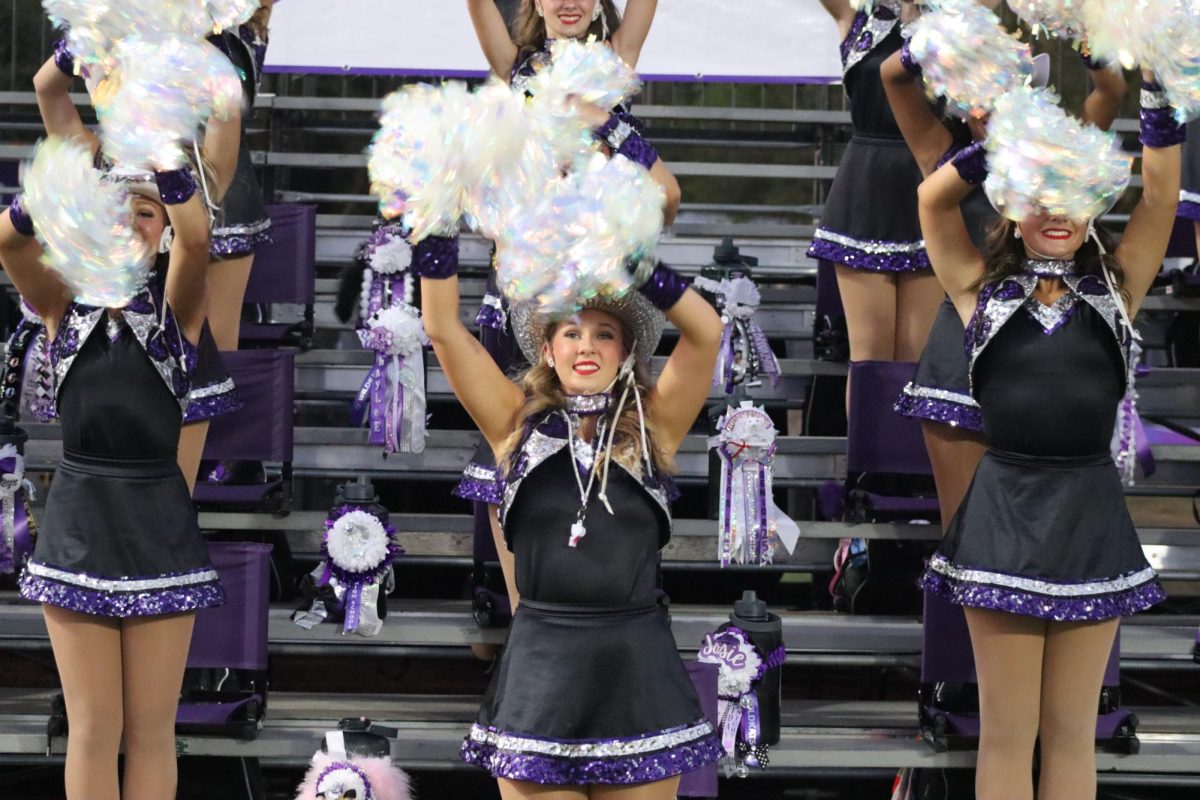 POMS AND SMILES.  Keeping the end zone full of spirit, the Sweethearts work during the homecoming game to show their undying school spirit.