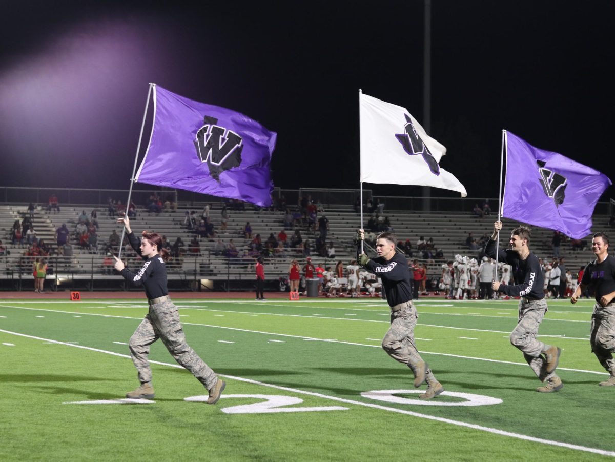 TOUCHDOWN CELEBRATION. After a Wildkat touchdown members of the Raider team run the flags from end zone to end zone.