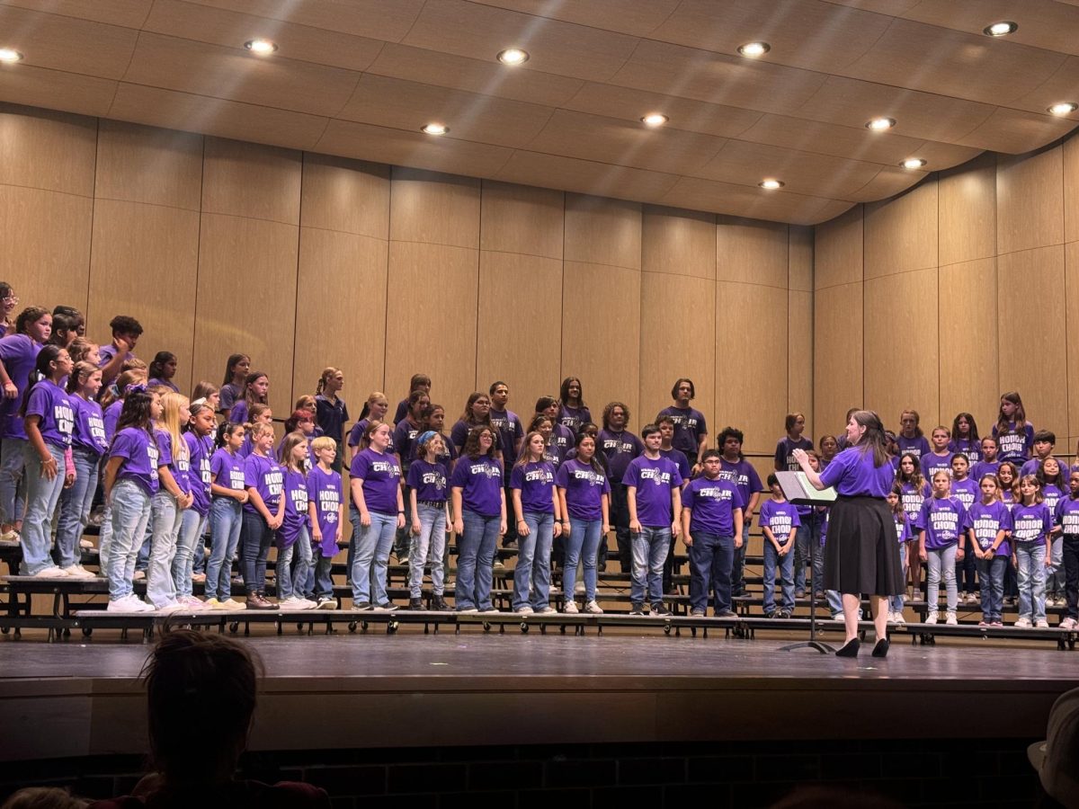 SING ALONG. The varsity choir with the various elementary schools come together to sing in front of families. On Saturday, 12 students were handpicked from each elementary school to get the opportunity to sing with the high school students. 