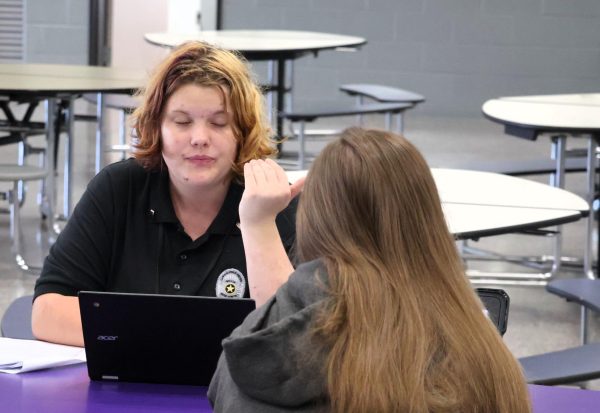 LOCKED IN. Giving advice on perfecting the DBQ, junior Ann Boyd talks to her mentor during a writers workshop during Wildkat Way.