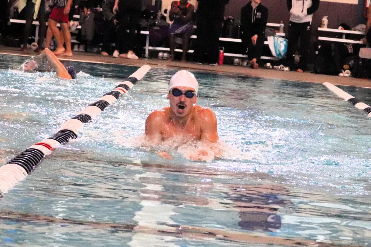 MAKIING RECORDS. Competing in a meet this fall, junior Aaron Barker swims for the AquaKats. Barker broke a record for the breaststroke that was set in 1993. 