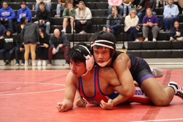 REGIONAL BOUND. With intensity, junior Steven Nguyen dominates over an opponent from Oak Ridge. The wrestling team competed in a tri against the Tigers and War Eagles.