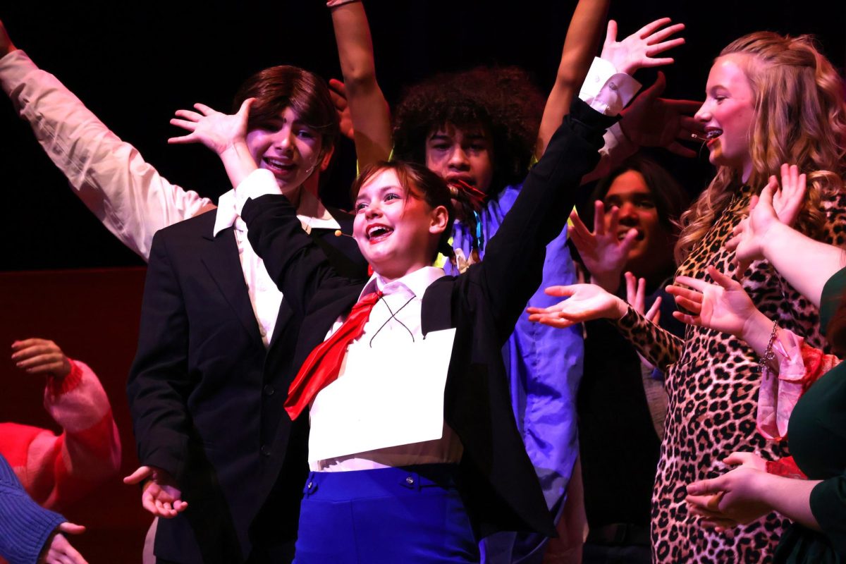 WOE IS ME. Having her moment in the spotlight, Schwartzy played by sophomore Olivia Cavello finishes her song surrounded by her dad, stepmom and fellow spellers. The musical, The 25th Annual Putnam County Spelling Bee, was a collaborative effort of the choir, drama and band departments. photo by Ella McDonald