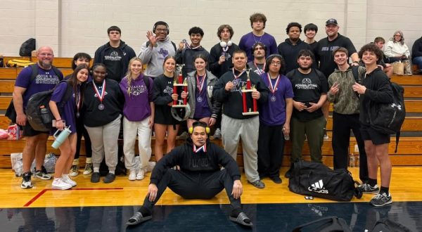 HEAVY LIFTERS. Coach Ryan Anthony and Coach Brian Fitzgerald take a picture with their team after the Oak Ridge tournament.  The boys and girls teams both took first place at the invitational.