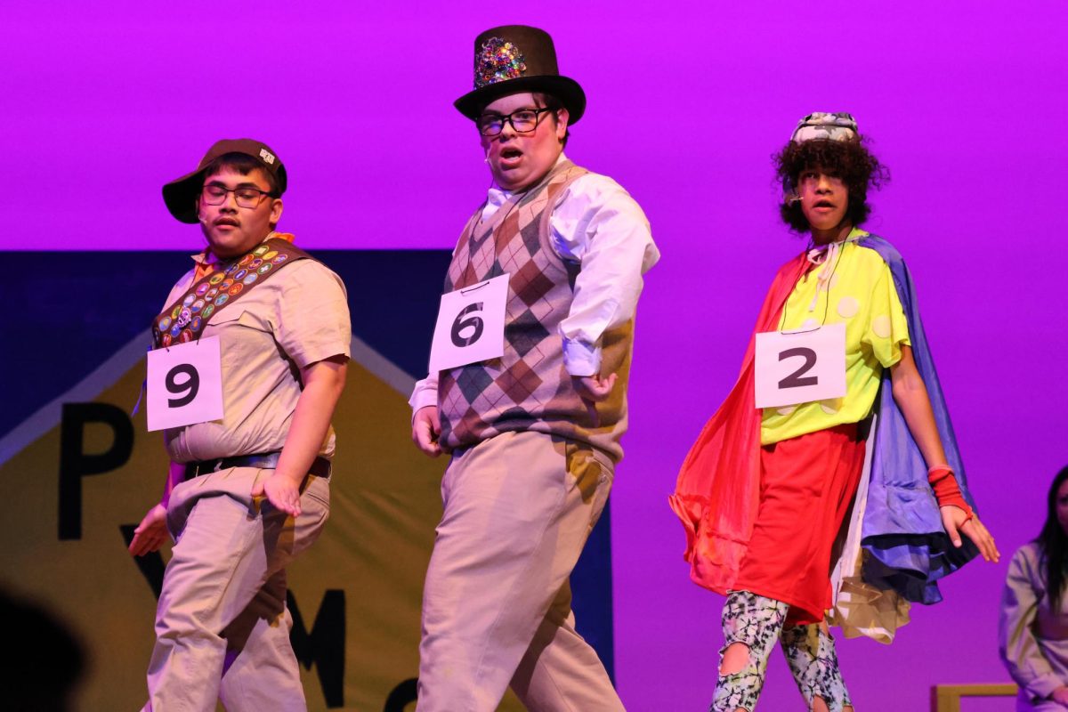 MAGIC FOOT.  Taking him to the final round, senior Kamden Frazier sings Barfee's song "Magic Foot." He is joined by Chip played by junior Jhun Abarquez and Leaf Coneybear played by Chege Wachege.