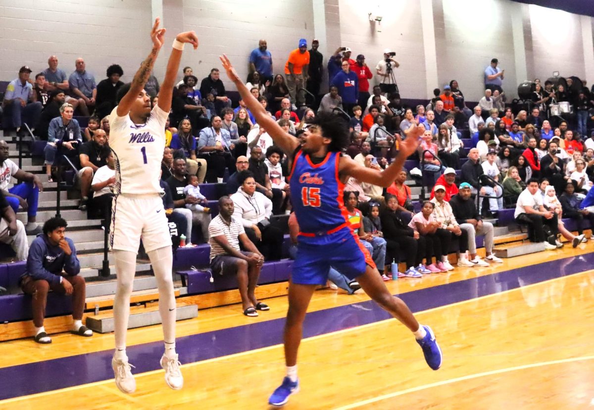 LEADING THE TEAM. Shooting for three, junior SJ Young plays in the district season closer against Grand Oaks. The team plays in the first round of the playoffs tonight. 