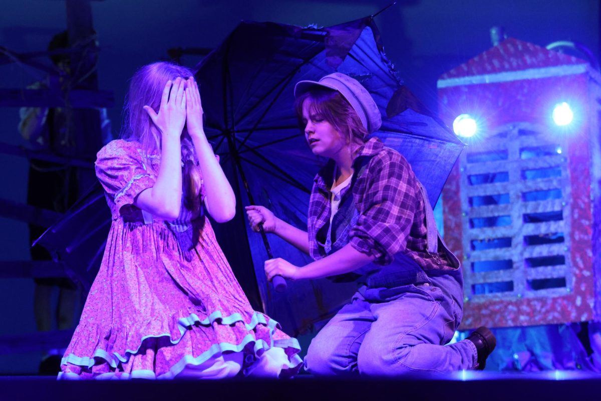 THE STORM INSIDE.  With the monster of the barn right behind them, Mabel played by freshman Ella Kouba and Jack played by sophomore Olivia Calvello find danger in the barn of a neighboring farm.  The monster puppet was controlled cast members and voiced by senior Amani Holly and freshman Carter Bernard.