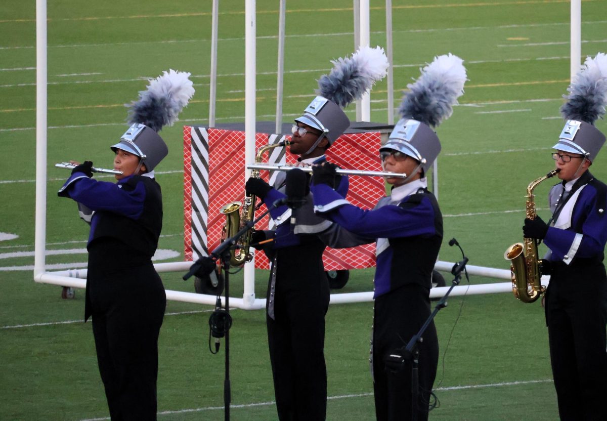 MULTITALENTED. Playing a flute during UIL Marching Contest, sophomore Drue  Walker competes with his fellow band members. Walker recently was named the top piccolo player in Texas.