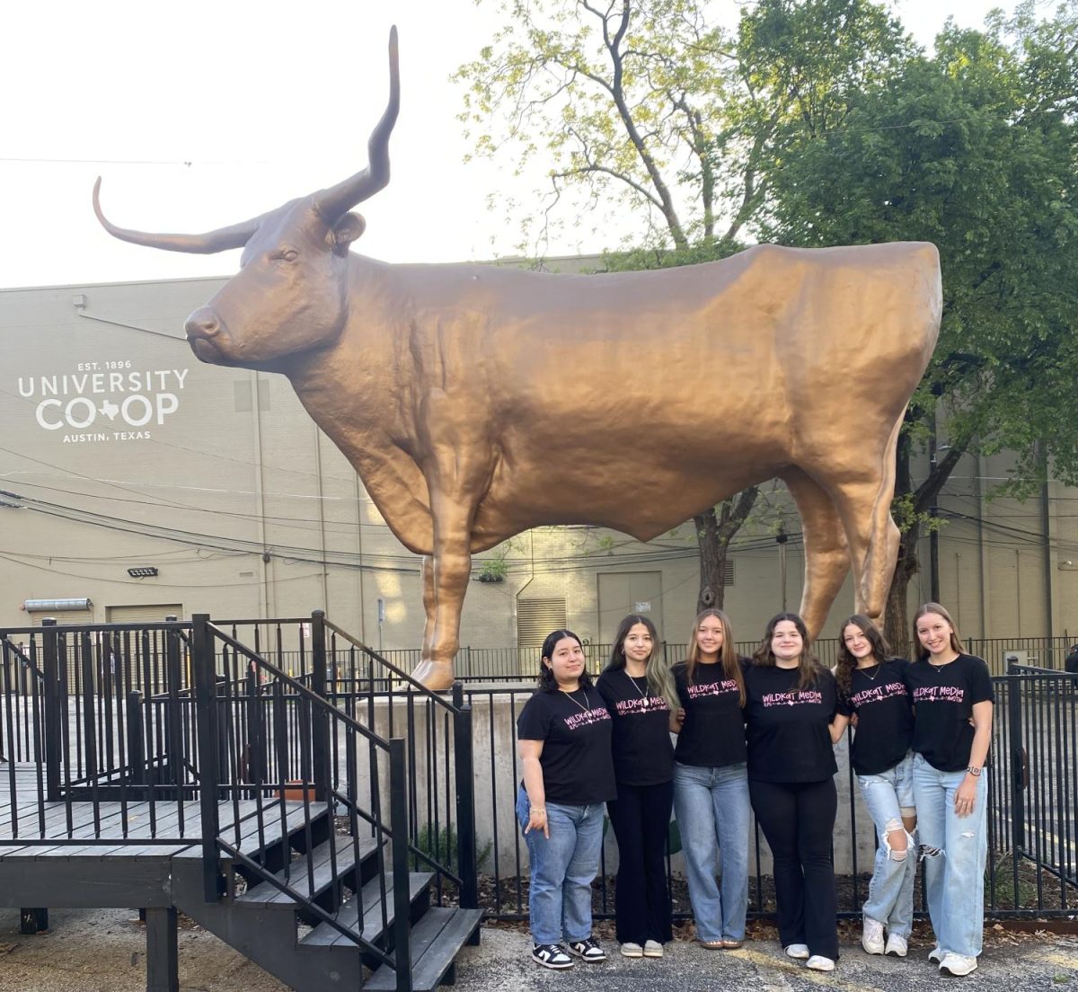HOOK 'EM. Members of Wildkat Media sop at the Bevo statue at the University Coop before heading to ILPC Conference. `