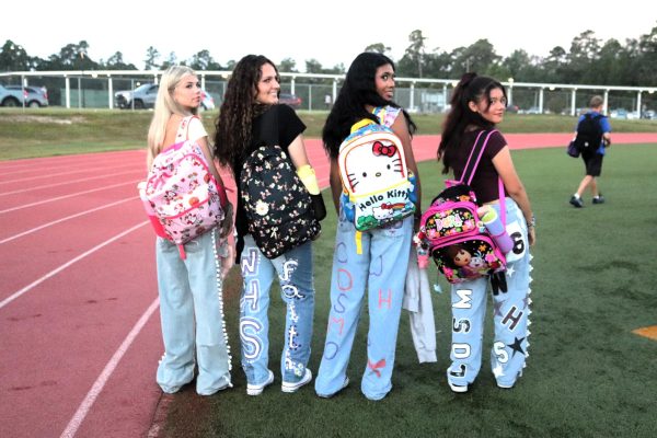 SENIOR STYLE. Showing off their new backpacks and decorated jeans, seniors Keira Johnson, Chloe Denna, Seleste Ramirez and Melanie Hernandez enjoy Senior Sunrise. Carrying kiddie backpacks is just one of the many senior traditions. 