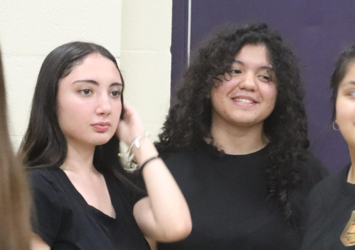 READY TO VOLUNTEER,. Waiting for the event to begin, sophomores Exiana Lopez and Ibeth Nunez join other Spanish NHS members at the CC Hardy Spanish Heritage Night. 