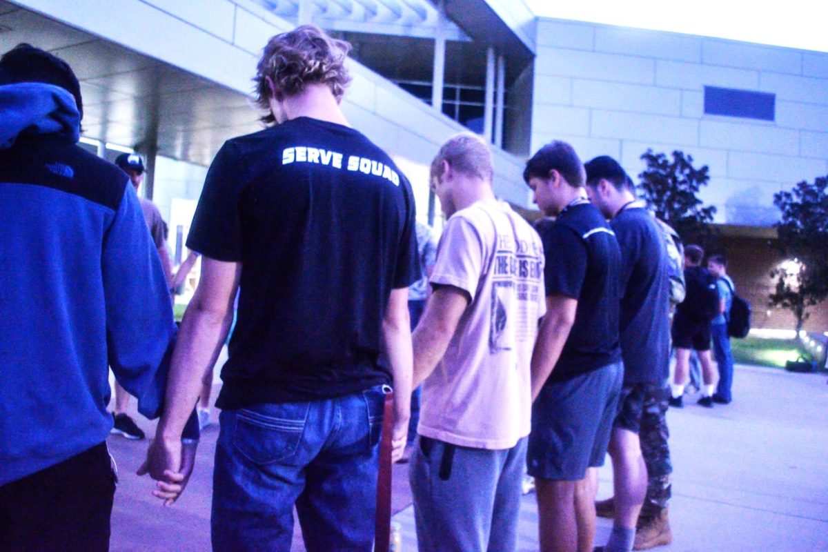 SINCE 1990. Students join hands in a prayer circle with local church members who came to join in fellowship.  See You at the Pole started at a school in Texas with one small group and now millions participate each year. 