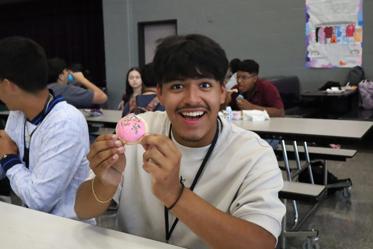 SMILES FOR SPRINKLES. Nick Orsorio is about to experience his favorite part of the school day, eating a delicious school cookie. His favorite cookie is the pink sprinkle sugar cookie.“The pink sugar cookie is definitely my favorite cookie because it has more flavor than the regular chocolate chip cookie”, junior Nick Orsorio said.“The cookie during lunch might be my favorite part of the day. I get at least three”
