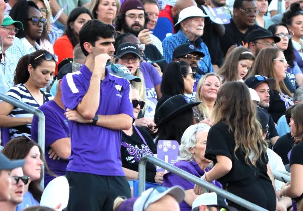 NEW WILDKAT. At the Woodlands game on Friday night, new choir director Jackson Howard supervises middle school choir members during middle school night. 