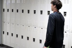 ON THE JOB. As part of his office aide duties, senior Braden Richardson delivers a pass during fourth period. Seniors fill the aide positions in offices, the library and some classrooms. 