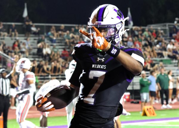 HOOK EM KATS. After one of many touchdowns in The Woodlands game, senior Jermaine Bishop, Jr. throws up his horns. Bishop has committed to UT for the fall.