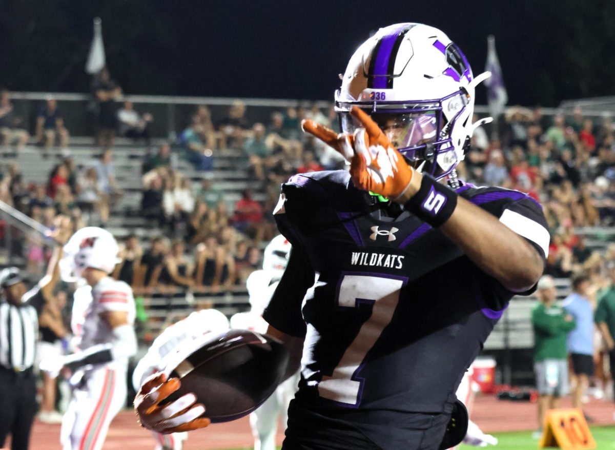 HOOK EM KATS. After one of many touchdowns in The Woodlands game, senior Jermaine Bishop, Jr. throws up his horns. Bishop has committed to UT for the fall.