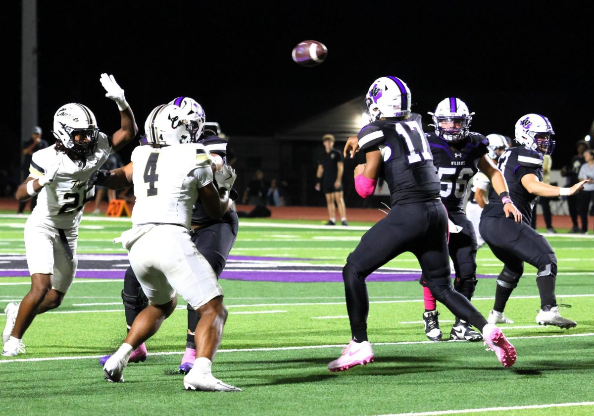 FRESHMAN FRENZY. Sending the ball to a receiver, freshman Linc Frazier play quarterback against rivals Conroe. In the 31-10 victory over the Tigers, Frazier had 322 passing yards with 19 completions. 