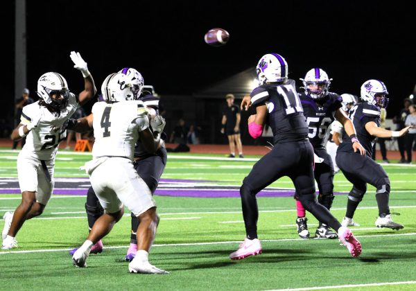FRESHMAN FRENZY. Sending the ball to a receiver, freshman Linc Frazier play quarterback against rivals Conroe. In the 31-10 victory over the Tigers, Frazier had 322 passing yards with 19 completions.