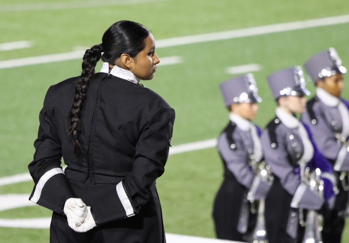 IN CONTROL. Waiting for the band to be ready, senior Sherly Ensaldo  leads as one of four drum majors of the band.