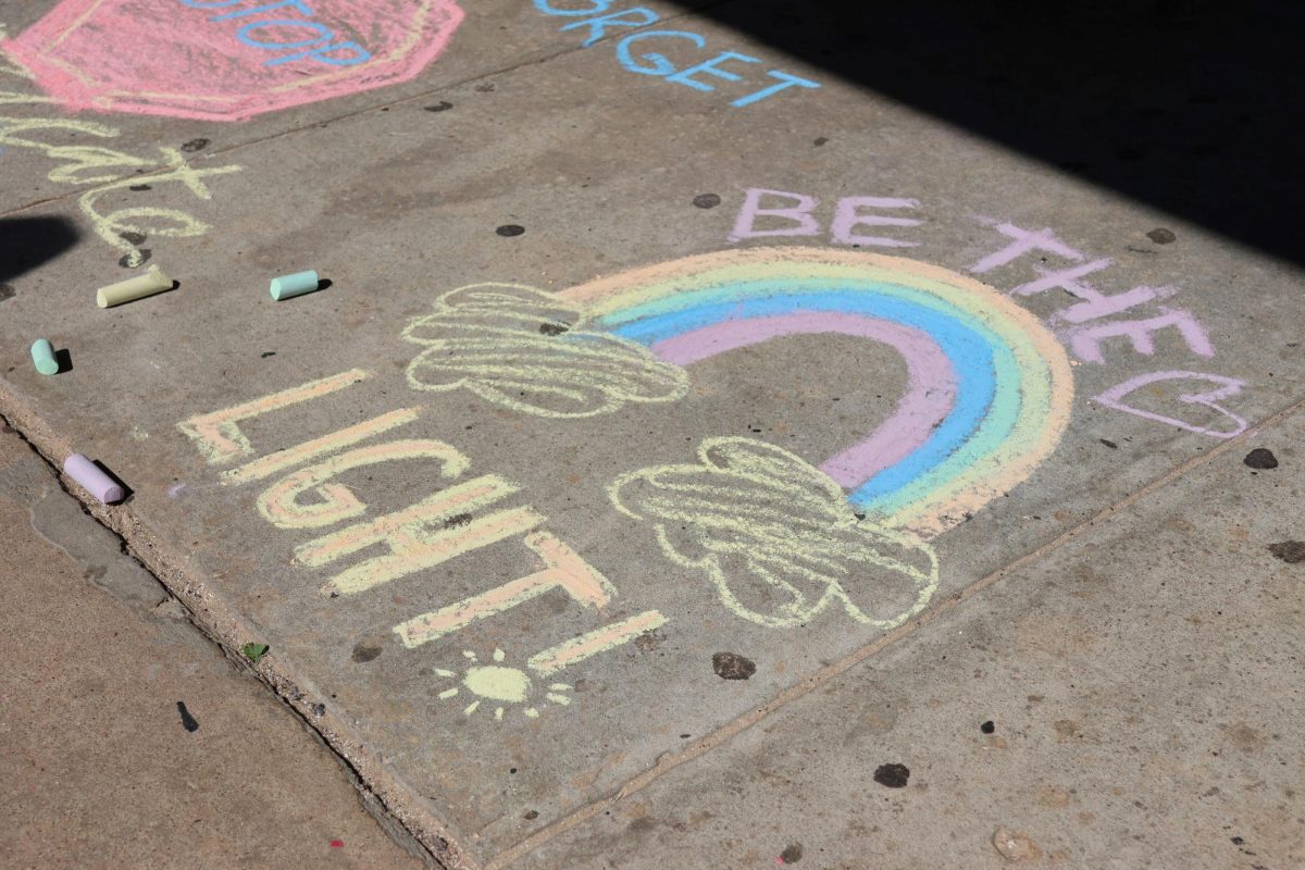 BE THE LIGHT. A positive message greets students on Friday. The club Balancing Bridges added the messages to the sidewalk to inspire others. 