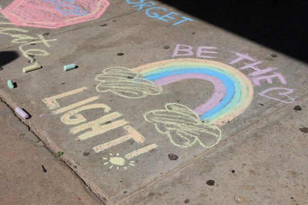 BE THE LIGHT. A positive message greets students on Friday. The club Balancing Bridges added the messages to the sidewalk to inspire others. 