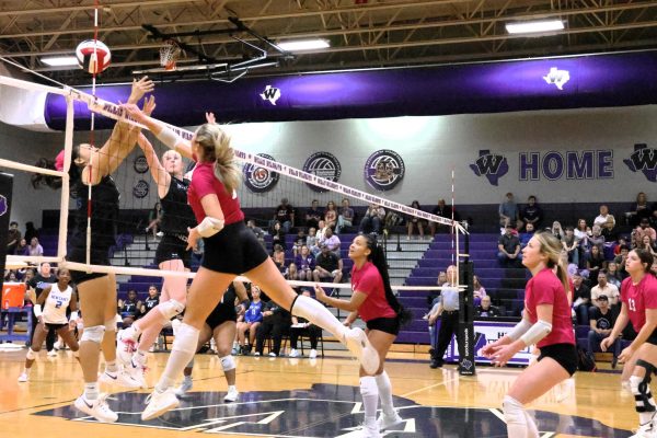 IN THE AIR. Slamming the ball to the other side of the net, senior Tori Greeney catches air as she spikes the ball. Greeney serves as the team captain this year and plans to play volleyball after high school on the collegiate level.