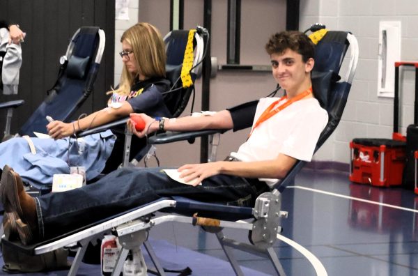 SAVING THREE LIVES. Relaxing while donating, senior Jacob Elliott donated during Monday's blood drive. Every student who donated was sent back to class with a t-shirt and snacks. 