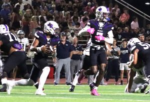 HAND OFF. Waiting for the handoff from quarterback freshman Lincoln Frazier during the homecoming game.  