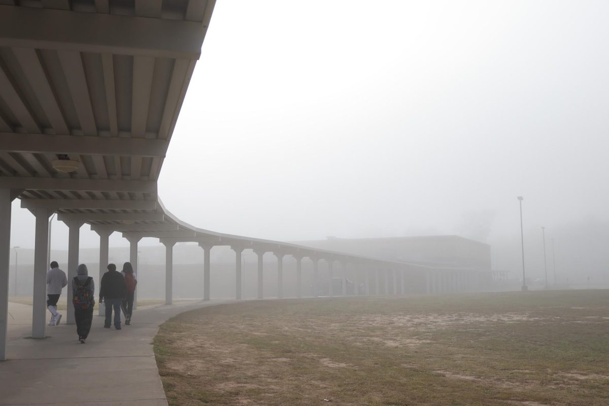HAZY MORNING. Enveloped in the fog, students make the walk from CTE building to the main building. A dense fog advisory was in effect until 9 a.m. with visibility dropping to a quarter mile or less in some areas. photo by Blake Sunday